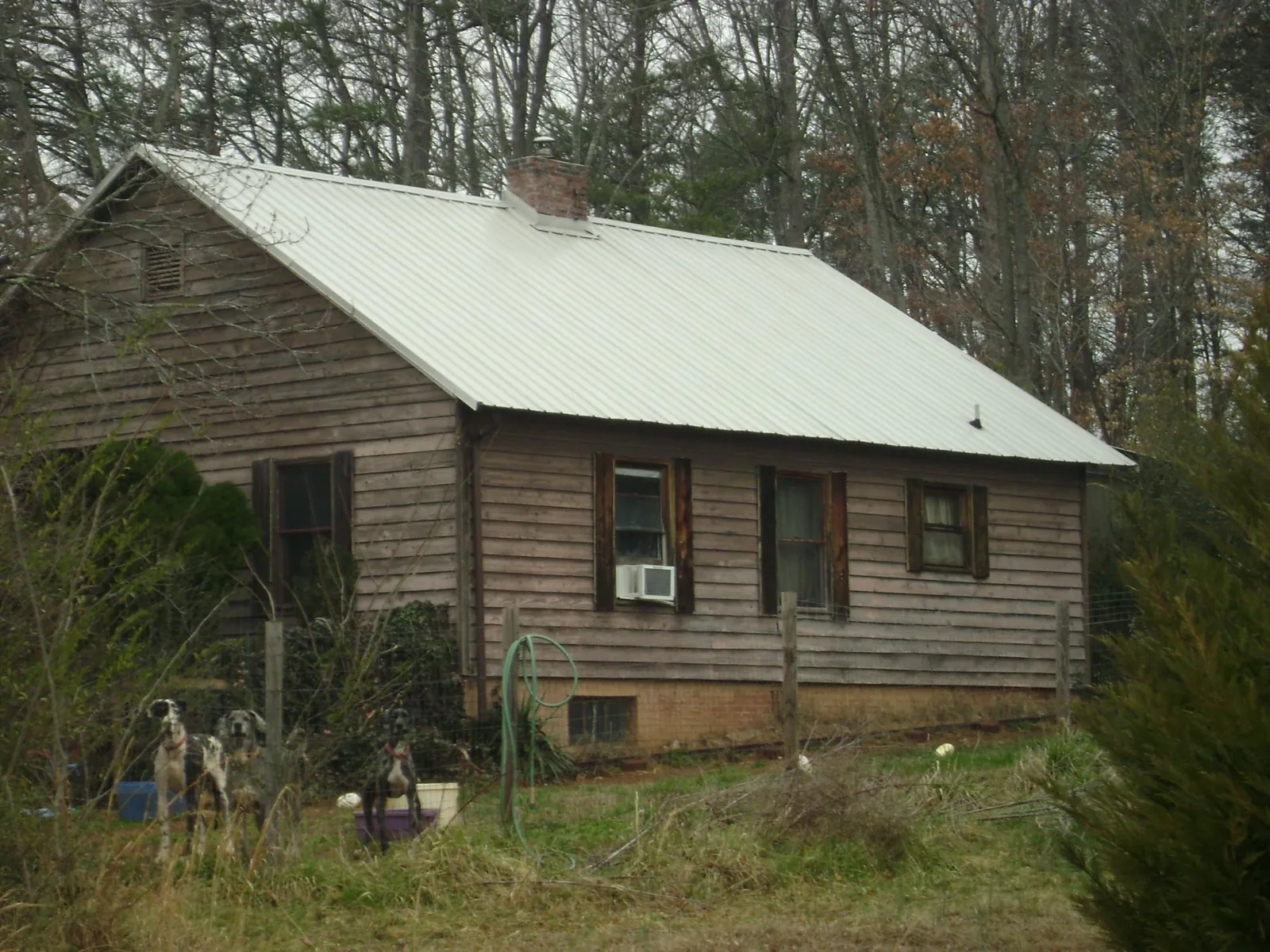 White metal roof on an old wood sided farmhouse, from a Asphalt Shingle Roof Repair job in Brimfield